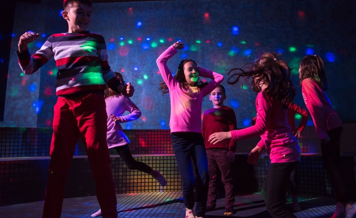children dancing on multicolored lit dance floor