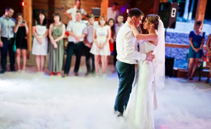 bride and groom dancing with layer of mist on dance floor