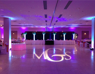 wedding couple monogram light projected on reception floor